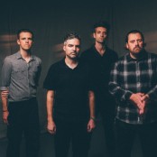 4 men (the boxer rebellion) standing in front of a dark sheet 